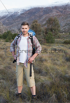 Man with backpack standing on forest landscape
