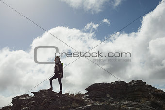 Woman on rock admiring the view after a hike