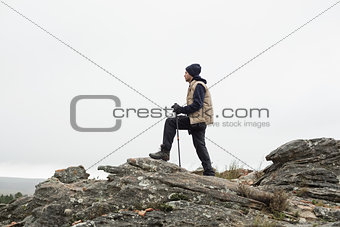 Man on rock admiring the view after a hike