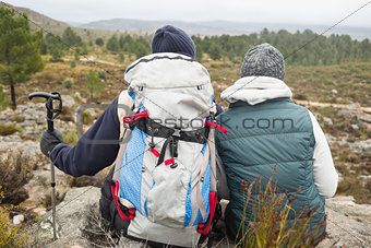 Couple with backpack and trekking pole on a hike