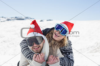 Close up of a cheerful couple in ski goggles on snow