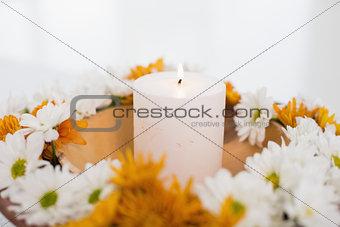 Flowers and a lit candle