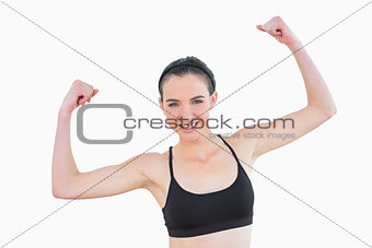 Portrait of sporty fit young woman clenching fists