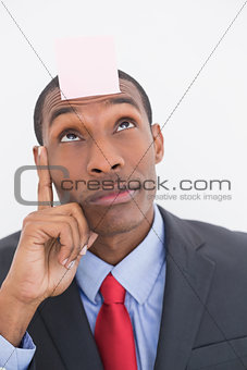 Afro businessman with blank note on forehead