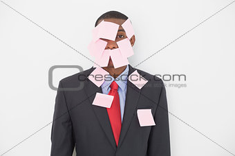 Portrait of an Afro businessman covered in blank notes