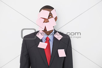 Young Afro businessman covered in blank notes