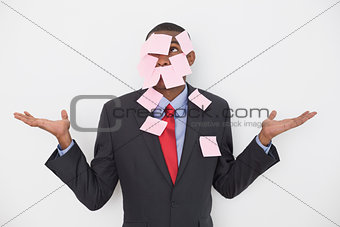 Young Afro businessman covered in blank notes