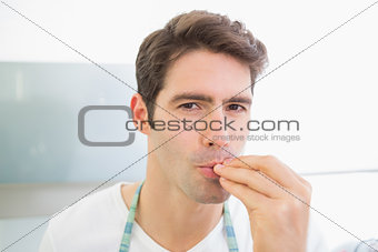 Close up portrait of a young man kissing fingers