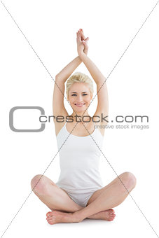 Sporty woman sitting in Namaskar pose with twisted hands