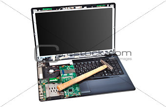 Laptop half disassembled with hummer on it