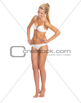 Full length portrait of laughing young woman in lingerie