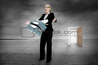 Shocked businesswoman dropping folders