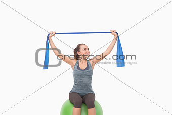 Cheerful woman training with a resistance band