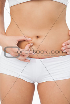 Young slim woman posing without any fat on her belly