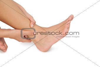 Close up of woman touching her injured foot