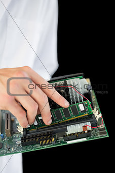 Extreme close up of computer engineer holding hardware at night