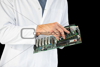 Close up of computer engineer holding hardware at night