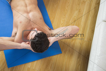 Overhead view of attractive man doing sit ups