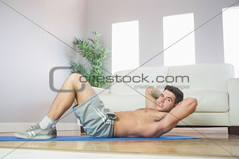 Sexy handsome man doing sit ups