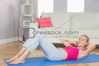 Sporty content blonde doing sit ups