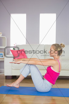 Sporty determined blonde doing core exercise