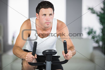 Attractive fit man exercising on bike