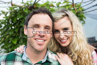 Beautiful young couple in a green house
