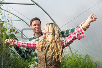 Sweet couple posing in their greenhouse