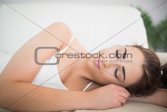 Peaceful young woman sleeping on a couch
