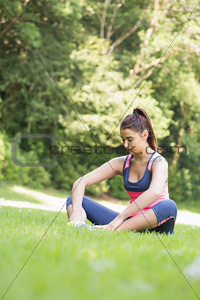 Young fit woman sitting on the ground