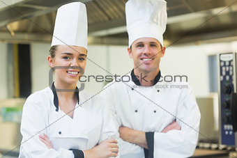 Two chefs smiling at the camera