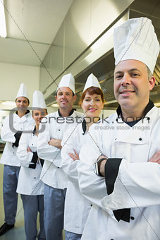 Team of happy chefs smiling at the camera