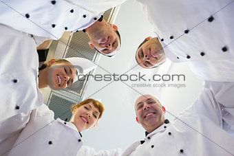 Five chefs standing in a circle