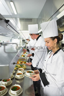 Four chefs working in a busy kitchen