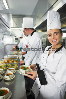Smiling chef showing her soup