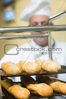 Mature baker pushing a trolley
