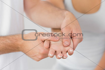 Physiotherapist massaging patients hand