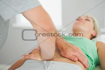 Physiotherapist checking patients pelvis alignment
