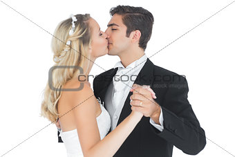 Young married couple dancing viennese waltz kissing each other