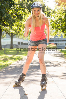 Casual smiling blonde inline skating