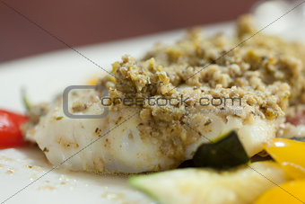 Close up of delicious fish dish with pesto