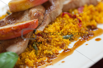 Close up of couscous with meat and apple