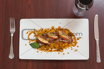 Overhead view of couscous dish with meat and red wine