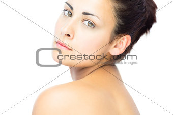 Pretty young woman looking over shoulder at camera