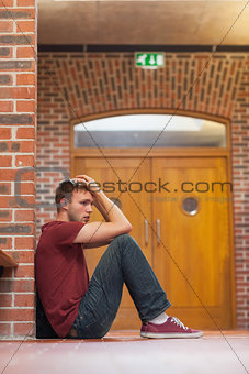 Unhappy handsome student having a headache