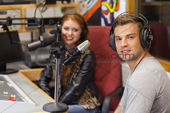 Attractive cheerful radio host interviewing a guest