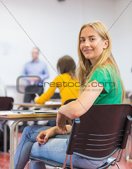 Female with blurred teachers students in classroom