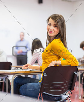 Female with blurred teachers students in classroom