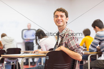 Male with blurred teachers students in classroom
