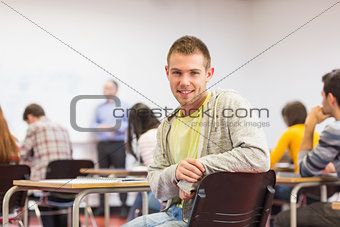 Male with blurred teachers students in classroom